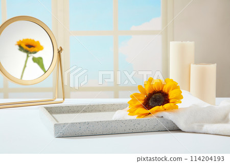 Bathroom layout with sky view window, blank tray displayed in center of white table with a bath towel and a sunflower above, bath accessories placed behind. Photo for promotion with blank space 114204193