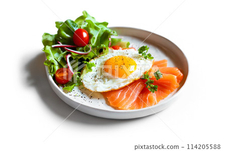 Fried egg, salmon and salad breakfast plate isolated on white background 114205588