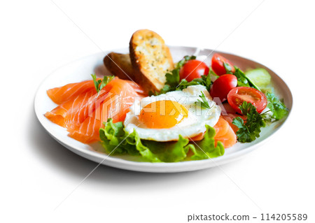 Fried egg, salmon and salad breakfast plate isolated on white background 114205589