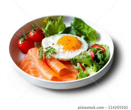 Fried egg, salmon and salad breakfast plate isolated on white background 114205592