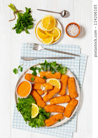 crispy fried breaded fish sticks on a plate 114206105