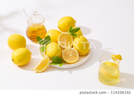 Top view at lemon photography with some fresh lemon and other natural ingredients flat lay on white background. Photo for advertising product of lemon Top view at lemon photography with some fresh lemon and other natural ingredients flat lay on white background. Photo for advertising product of lemon 114206192