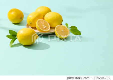 Plenty fresh lemons placed on round dish flat lay on light blue background. Blank space for adding text or elements of design, lemon can also be used in skin and hair care Plenty fresh lemons placed on round dish flat lay on light blue background. Blank space for adding text or elements of design, lemon can also be used in skin and hair care 114206209