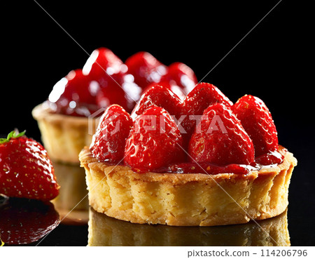 Strawberry tart on a black background Strawberry tart on a black background 114206796