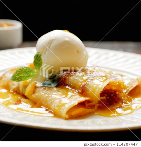 Crepes Suzette topped with vanilla ice cream Crepes Suzette topped with vanilla ice cream 114207447