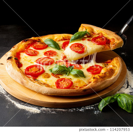 Pizza Margherita slice lifted up on black background Pizza Margherita slice lifted up on black background 114207953