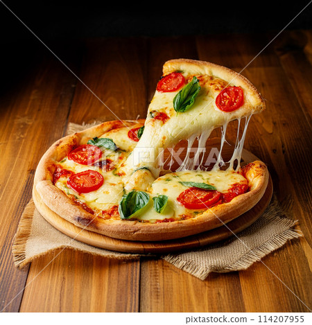 A slice of pizza Margherita lifted up on a wooden table background A slice of pizza Margherita lifted up on a wooden table background 114207955
