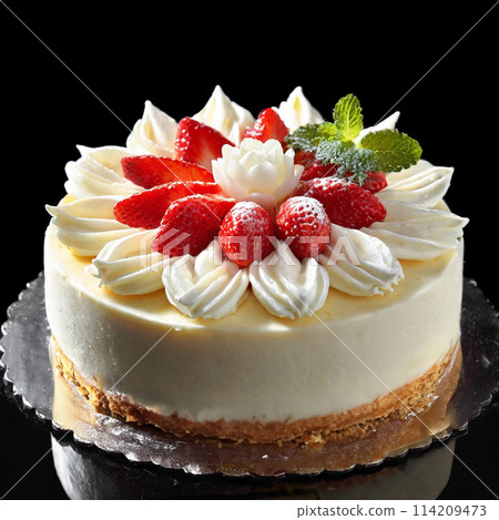Gorgeous strawberry and white chocolate decorated cake on a black background Gorgeous strawberry and white chocolate decorated cake on a black background 114209473