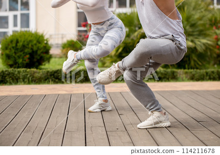 Young couple doing yoga outdoors 114211678