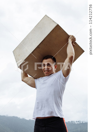 Cross Fit Weight Lifting exercise man workout outdoor, lifting heavy jump box. 114212756