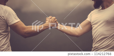 Two caucasian athletes in sportive wear measuring forces at outdoor training 114212768