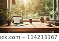Laptop on table with lush garden view in cozy atmosphere 114213167