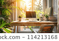 computer on window table with lush garden view 114213168