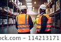 Staff overseeing inventory in bustling warehouse environment 114213171