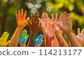 People raise multicolored hands, symbolizing unity in diversity 114213177