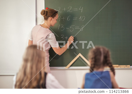 teacher with marker standing at white board at lecture teacher with marker standing at white board at lecture 114213866