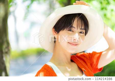A woman wearing a straw hat 114214166