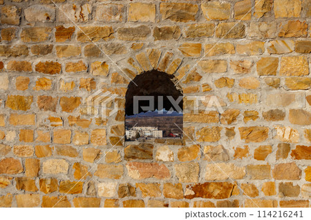 Background of the old stone wall with a loophole Background of the old stone wall with a loophole 114216241