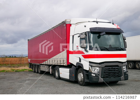 The white truck and red container Stop on rest area station near highway The white truck and red container Stop on rest area station near highway 114216987