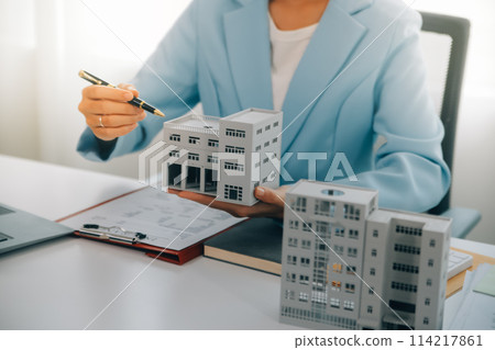 Real estate agent talked about the terms of the home purchase agreement and asked the customer to sign the documents to make the contract legally, Home sales and home insurance concept. 114217861