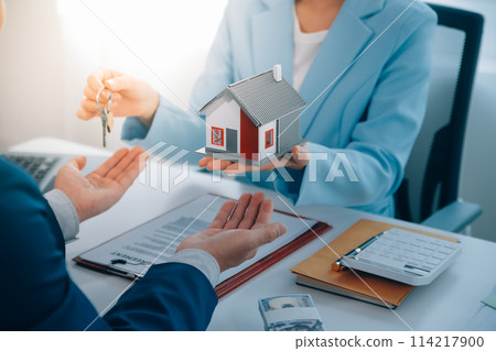 Real estate agent talked about the terms of the home purchase agreement and asked the customer to sign the documents to make the contract legally, Home sales and home insurance concept. Real estate agent talked about the terms of the home purchase agreement and asked the customer to sign the documents to make the contract legally, Home sales and home insurance concept. 114217900