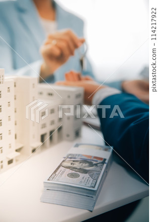 Real estate agent talked about the terms of the home purchase agreement and asked the customer to sign the documents to make the contract legally, Home sales and home insurance concept. 114217922