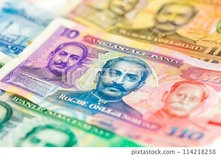 Indian currency notes of various denominations swirl around in a chaotic display, showcasing the rich and diverse economy. 114218238
