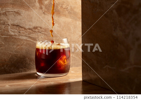Black iced coffee on a ceramic table. Black iced coffee on a ceramic table. 114218354