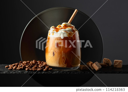 Iced coffee with whipped cream and caramel sauce. Iced coffee with whipped cream and caramel sauce. 114218363