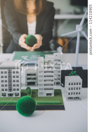 Eco business company meeting with group of business people using laptop to plan strategy and discuss marketing of eco-friendly and clean energy products. Green business company concept. Trailblazing 114218905