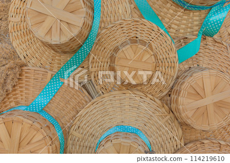 Set of pile of color dry straw hats summer headdress object with blue ribbon Set of pile of color dry straw hats summer headdress object with blue ribbon 114219610