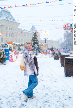 A woman in a Russian folk headscarf on her head in the Moscow 114220129