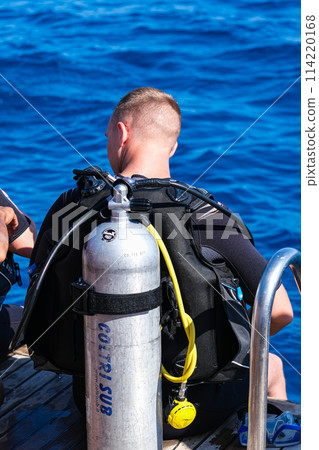 Scuba diver before diving. A diving lesson in open water. Scuba diver before diving. A diving lesson in open water. 114220168