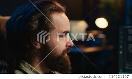 Man getting scared while programming after AI becomes sentient, afraid of it spiraling out of control and dooming humanity. Developer worried by conscious artificial intelligence, camera A close up 114221197