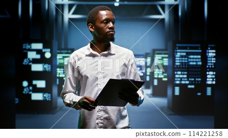 African american engineer doing maintenance in data center providing vast computing resources and storage, enabling artificial intelligence to process massive datasets for training and inference 114221258