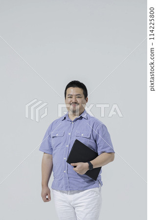 A large Japanese man with a laptop A large Japanese man with a laptop 114225800