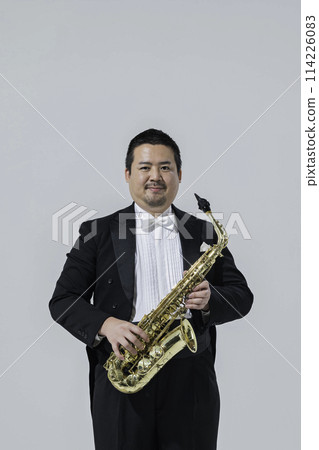 A large Japanese man playing the saxophone 114226083