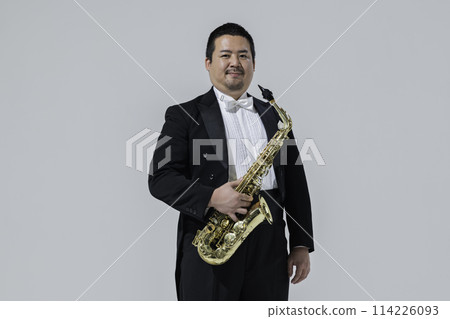 A large Japanese man playing the saxophone 114226093