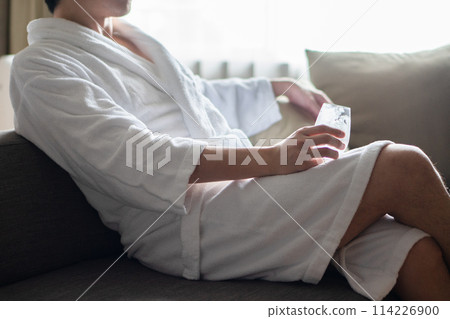 Man wearing a bathrobe 114226900