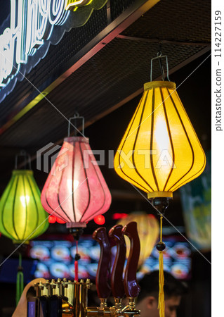 Colorful lanterns illuminate the restaurant, creating a vibrant atmosphere 114227159