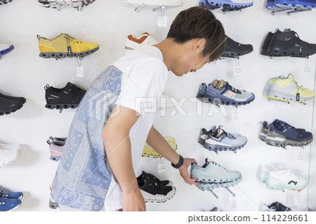 Young man shopping at a sports apparel store Young man shopping at a sports apparel store 114229661