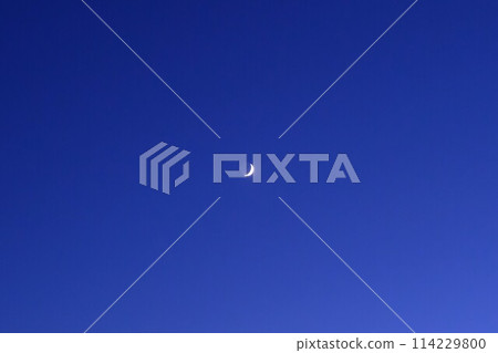 A crescent moon floating in the twilight sky A crescent moon floating in the twilight sky 114229800