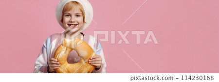 Banner child on a pink background wearing a chef's hat holding a bagel 114230168