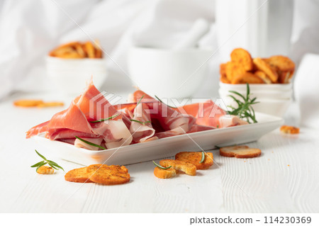 Prosciutto with rosemary and spicy bruschetta crackers. Prosciutto with rosemary and spicy bruschetta crackers. 114230369