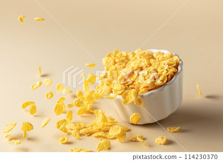 Dry honey cornflakes in a ceramic plate. Dry honey cornflakes in a ceramic plate. 114230370
