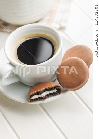 Freshly Brewed Coffee in Cup With Chocolate Cookies on Saucer Freshly Brewed Coffee in Cup With Chocolate Cookies on Saucer 114232501