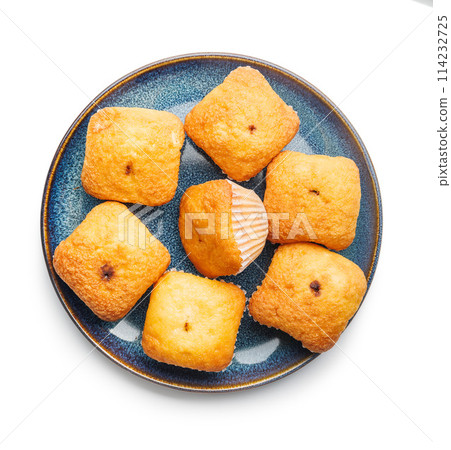 Magdalenas the typical spanish plain muffins on plate isolated on white background. 114232725