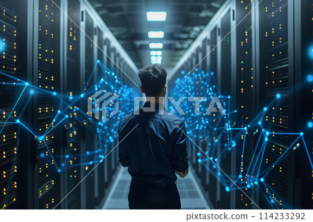 Young man in a modern data center. Network management and the work of AI mind Young man in a modern data center. Network management and the work of AI mind 114233292