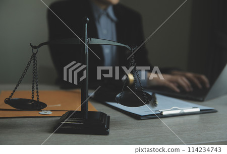 Business and lawyers discussing contract papers with brass scale on desk in office. Law, legal services, advice, justice and law concept picture with film grain effect Business and lawyers discussing contract papers with brass scale on desk in office. Law, legal services, advice, justice and law concept picture with film grain effect 114234743