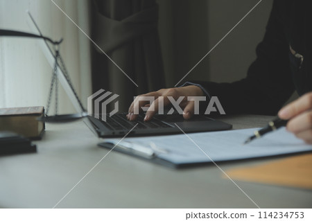 Business and lawyers discussing contract papers with brass scale on desk in office. Law, legal services, advice, justice and law concept picture with film grain effect 114234753